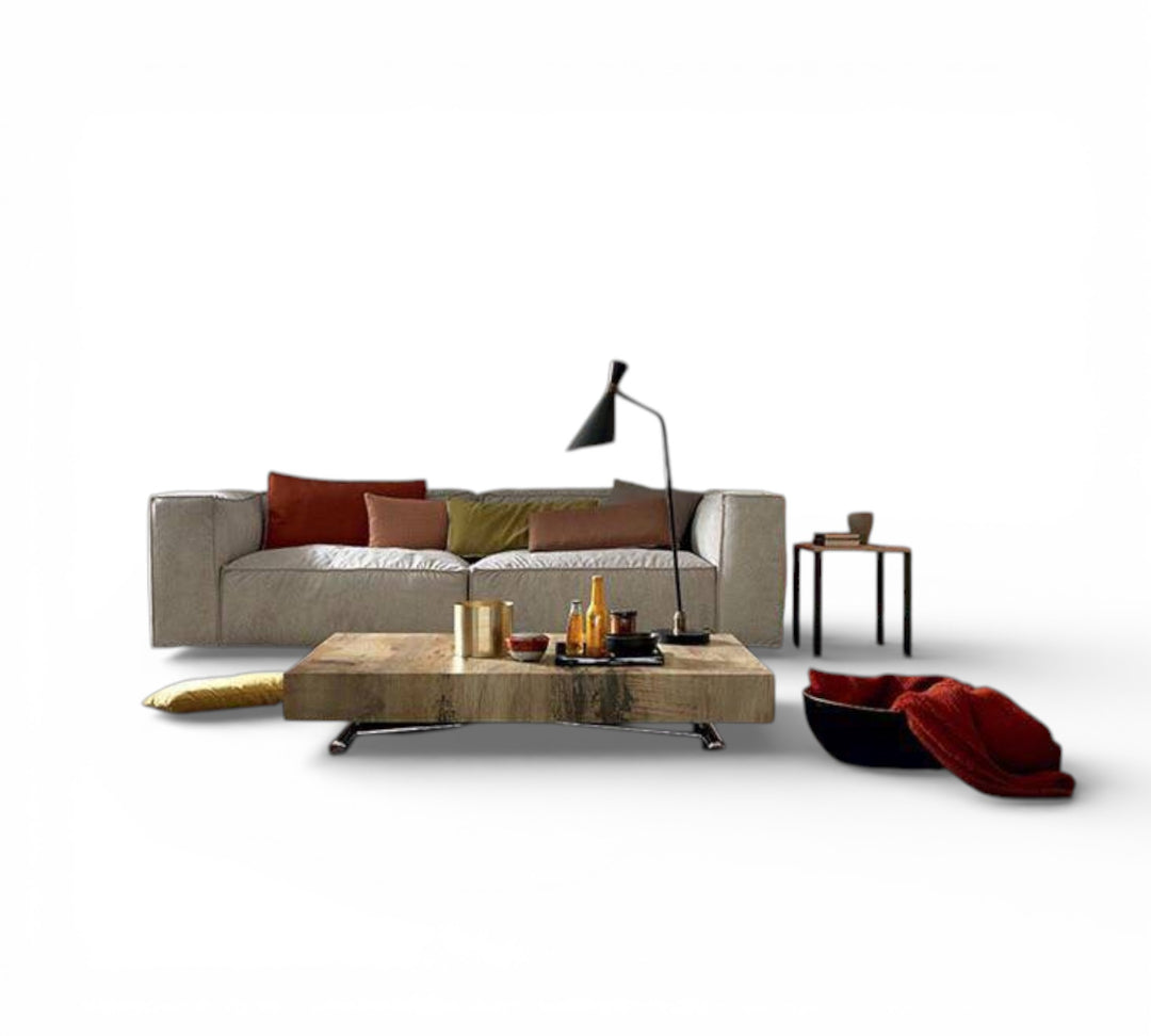 Boxy XL modern living room setup with a sofa, coffee table, and decorative items on a white background