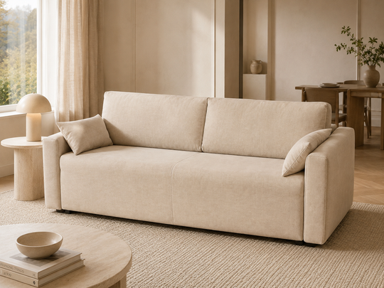 our modern beige fabric Flip sofa bunk bed with two matching throw pillows, styled in a warm, minimalist living room with wood floors, a round side table, and a window in the background.