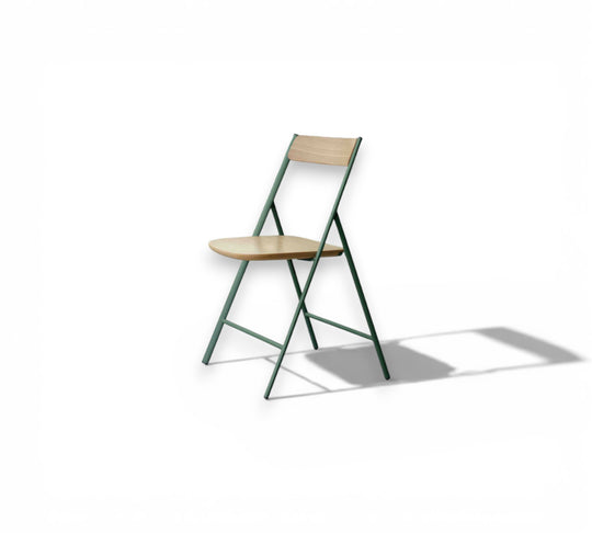 Joe Wood Foldable dining chair with wooden seat and green metal frame on a white background