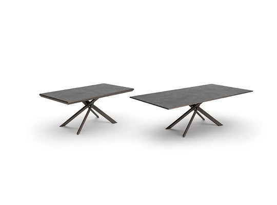 Two dark gray outdoor 4x4 tables with unique leg designs on a white background