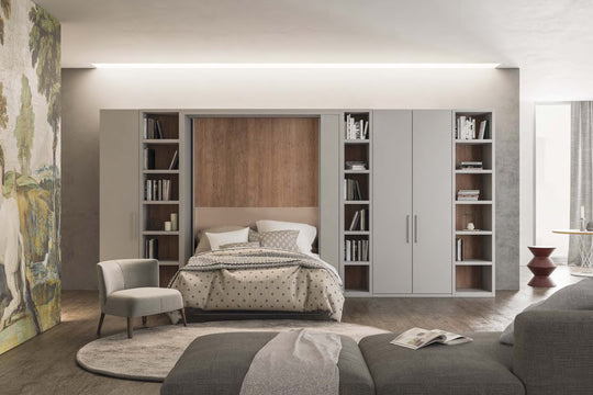 Orbit Swivel wall bed in a living room setup, bookshelves, and a sofa.