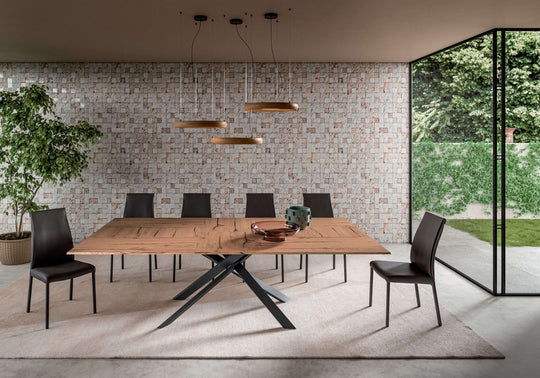 Dining area with a wooden 4x4 table and chairs in a modern interior setting.