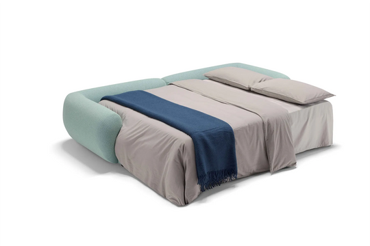 Modern Space horizontal sofabed with beige bedding and a blue throw blanket on a white background