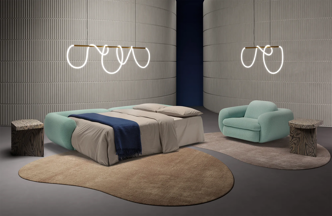 Modern bedroom with Space sofa bed set as a bed, Space swivel armchair, and decorative lights.