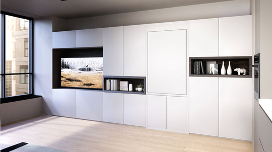 Modern foldaway table inwhite cabinets, black shelves, and a large window.