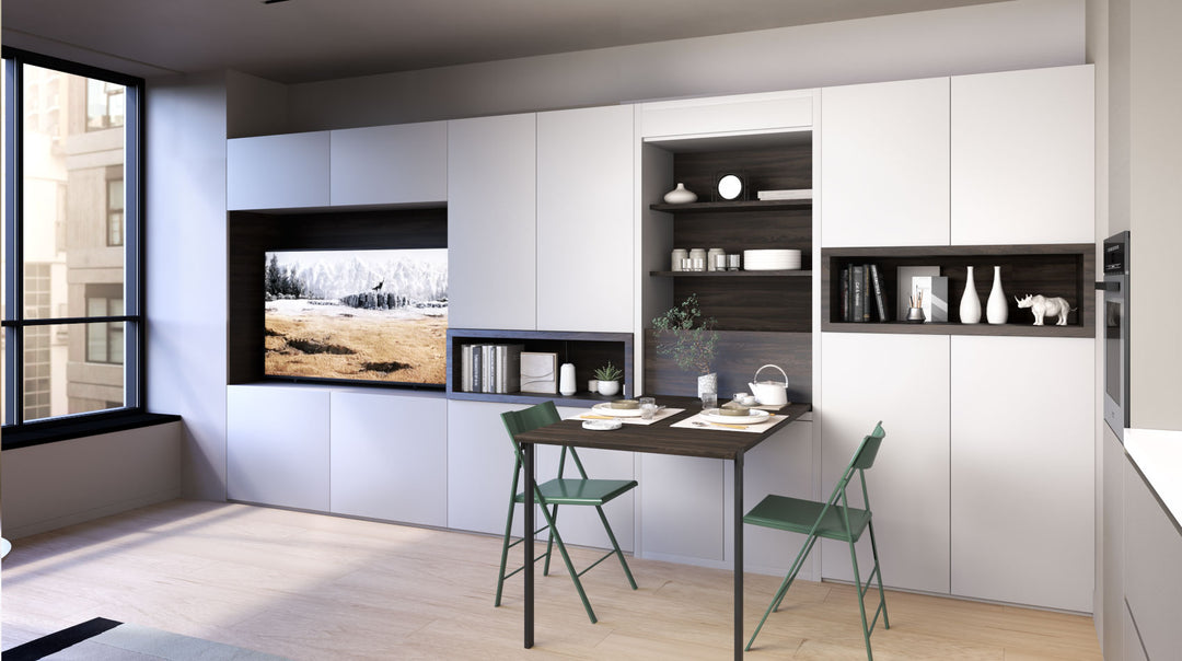Modern foldaway dining table in a white cabinet and green chairs.