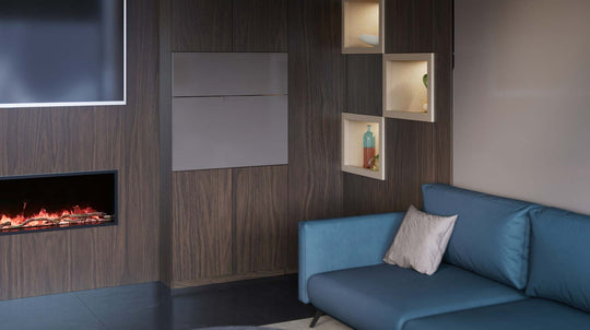 Modern living room with a blue sofa, wooden wall with built-in Home Office, shelves and a fireplace.